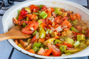 Cooking caponata in a large frying pan