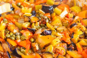 Cooking caponata in a large frying pan