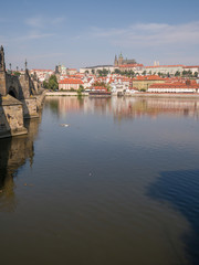 Fototapeta na wymiar Panorama of Prague with a part of the Charles Bridge and the river. Czech capital.