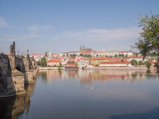 Fototapeta na wymiar Panorama of Prague with a part of the Charles Bridge and the river. Czech capital.