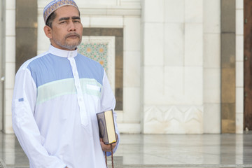 Middle age muslim man praying at mosque.