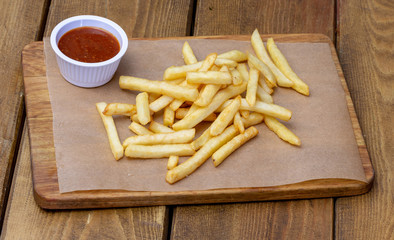 French fries on the wooden board