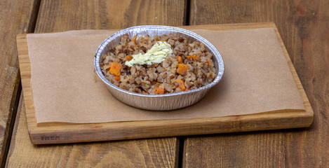 Buckwheat with butter on a wooden board