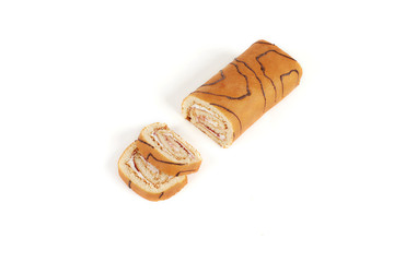 Biscuit roll cut into pieces, on a white background.