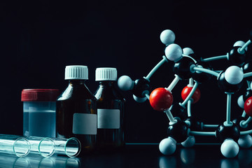 molecular formula and laboratory equipment on a dark background with copy space. Science organic...