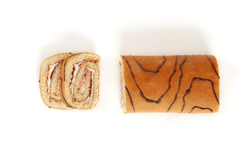 Biscuit roll cut into pieces, on a white background.