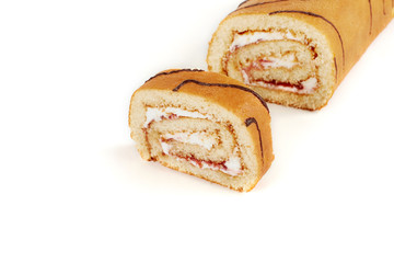 Biscuit roll cut into pieces, on a white background.