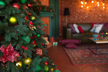 Fototapeta na wymiar Modern interior of living room. Creative Christmas tree, contemporary fireplace and large olive sofa in loft interior design apartment