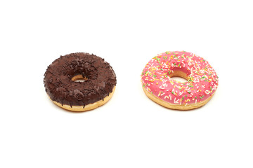 Tasty chocolate donut and Pink donut with colorful sprinkles on white background