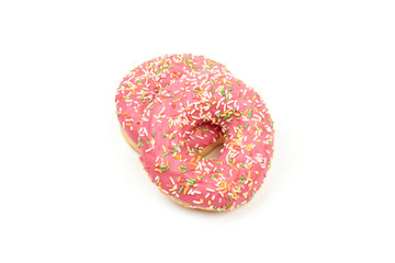 Pink donut with colorful sprinkles isolated on white background.