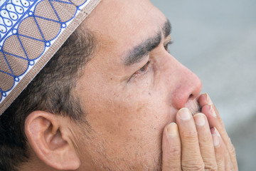 Middle age muslim man praying at mosque.