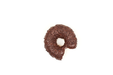Bitten chocolate donut with sprinkles isolated on white background. Top view