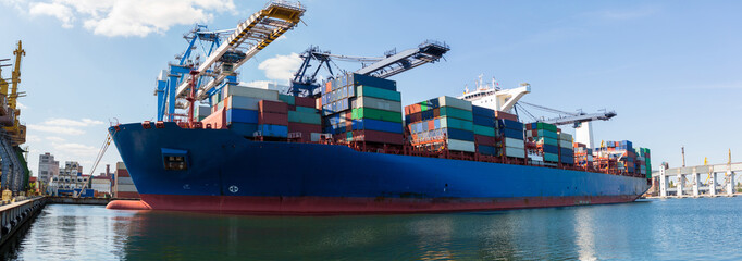 Container ship in port at container terminal. Ships of container ships stand in terminal of port on...