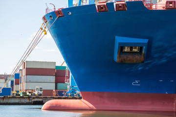 Container ship in port at container terminal close-up. Ships of container ships stand in terminal...