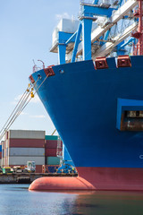 Container ship in port at container terminal close-up. Ships of container ships stand in terminal...
