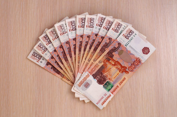 Russian five-thousandth banknotes spread out like a fan on the table