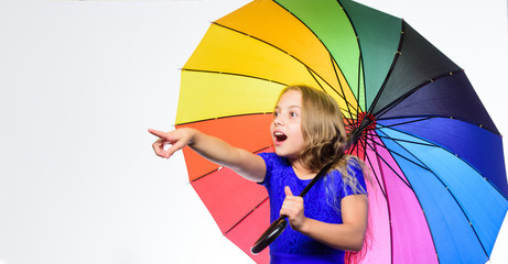 Happy little girl with umbrella, copy space. Small girl with umbrella in rainy weather. Happy childhood. School time. Autumn fashion. Child. Feeling protected at this autumn day. Can you see that