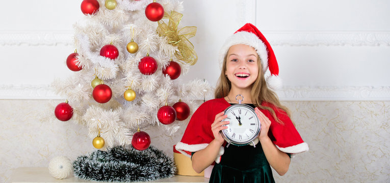 New year countdown. Girl kid santa hat costume with clock excited happy face counting time to new year. Last minute till midnight. Last minute new years eve plans that are actually lot of fun