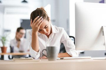 Business woman sitting in office working with computer.
