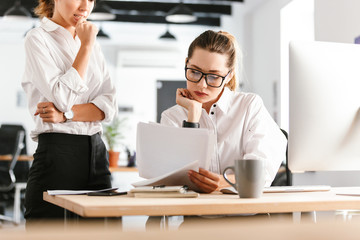 Concentrated nervous colleagues business women in office working.