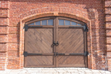 Wooden gate in a brick wall