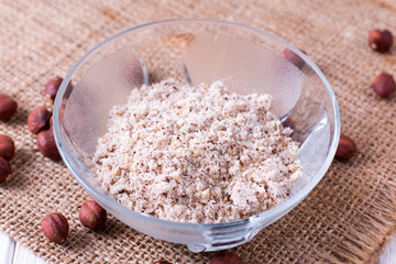 Glass bowl of roasted crushed hazelnut