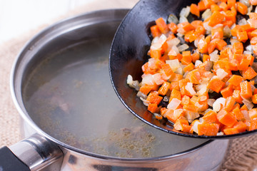 Chopped carrots frying on the pan. Healthy eating and lifestyle