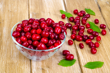 Autumn ripe cornel berries on wooden table