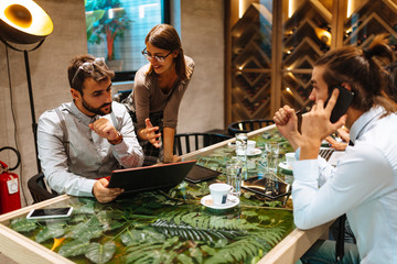Young business people meeting at a cafe