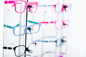 Closeup view of different colorful glasses for kinds on the showcase in the optical store