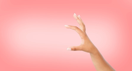 black hand measuring invisible items or hold something, isolated on pink background.Woman's palm...