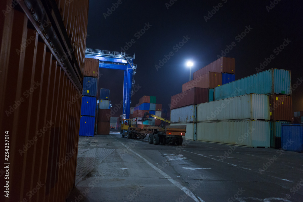 Wall mural industrial port with stack containers in night time