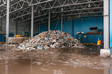A pile of garbage in a waste storage area at a waste sorting plant. Technological process. Business...