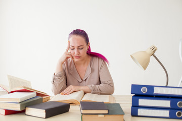 beautiful business woman at the table works in the Office book