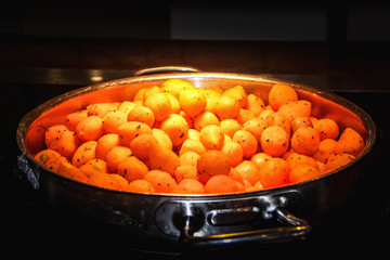 Fried carrots balls in a metal pan