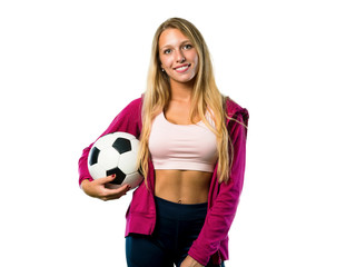 Pretty sport woman holding a soccer ball on isolated white background