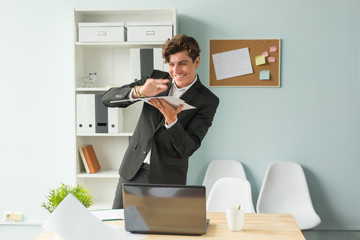 Business, joke, people concept - happy man throwing the paper because he has finished his work