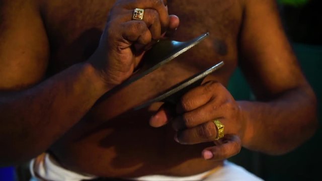 A panning, close-up shot of manjira, a traditional hand percussion instrument in India.