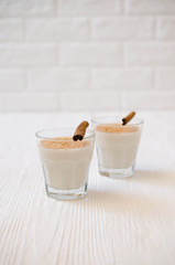 Christmas Traditional Homemade Eggnog on white background. Milk Cocktail with Spice.