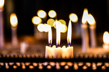 woman hand lighting candles in a church