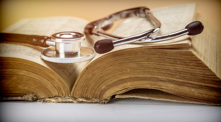 Stethoscope on an old medical book, concept image