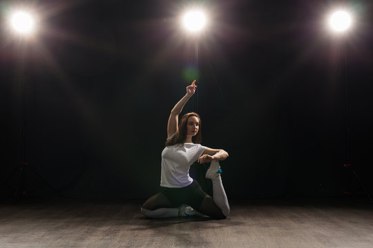 People And Dance Concept - Young Woman Dancing Jazz Funk Over Dark Background