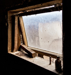 Old window in dark barn as background
