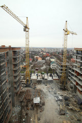 Construction of a residential multi-storey building. Working crane on the construction of the house