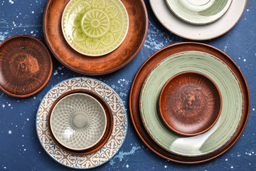 Set of clean color plates on table