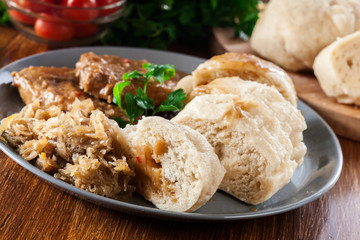 Pork loin in gravy with bread dumplings and sauerkraut