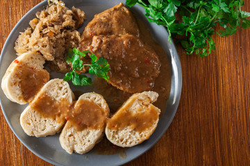 Pork loin in gravy with bread dumplings and sauerkraut
