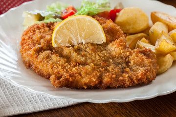 Breaded viennese schnitzel with baked potatoes
