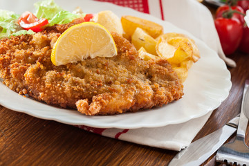 Breaded viennese schnitzel with baked potatoes