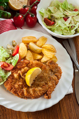Breaded viennese schnitzel with baked potatoes